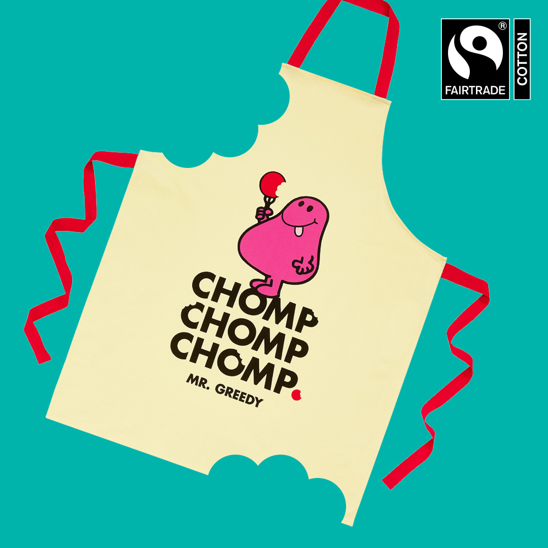 Fairtrade cotton apron featuring Mr. Greedy holding a red lollipop with the words “CHOMP CHOMP CHOMP” on a teal background.