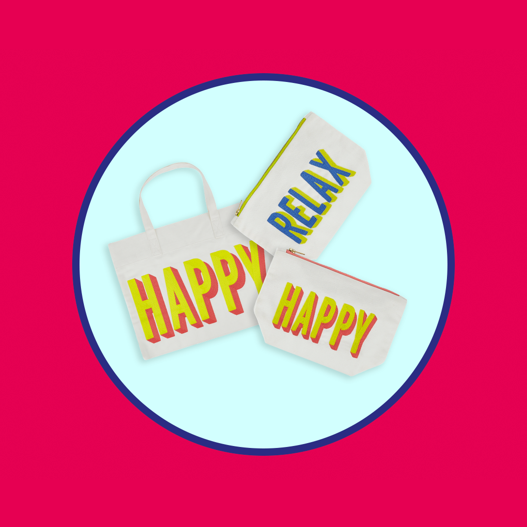 Three white fabric pouches and a tote bag with bold text reading "HAPPY" and "RELAX" in colorful 3D lettering, set against a light blue circle on a red background.