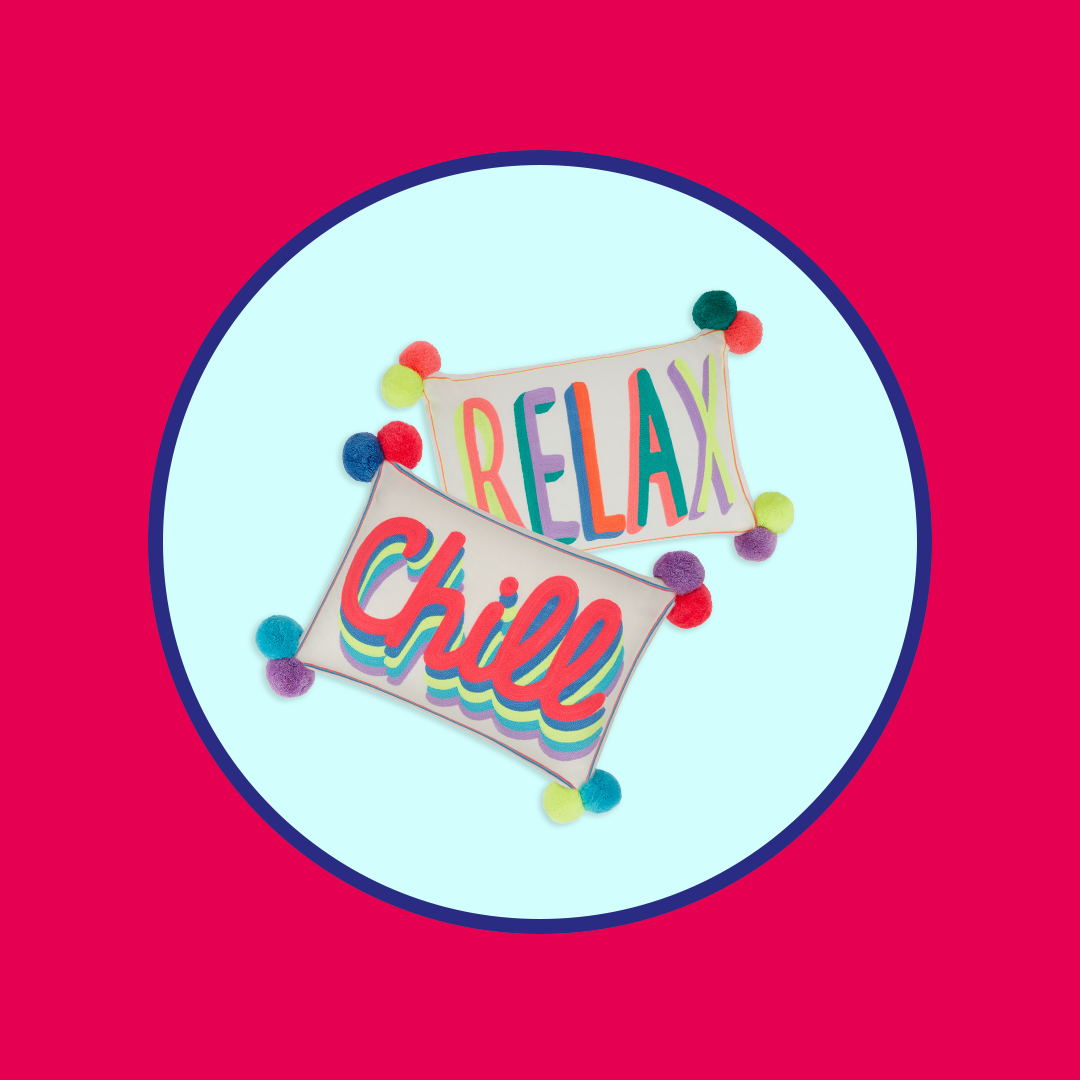 Two colorful rectangular cushions with pom-poms, one reading "RELAX" and the other "Chill", on a light blue background with a dark blue border.
