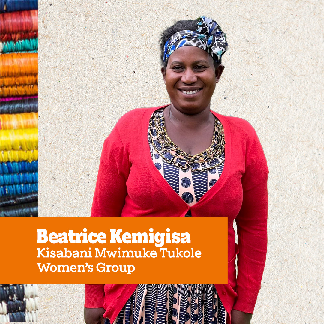 A woman named Beatrice Kemigisa from the Kisabani Mwimuke Tukole Women’s Group, smiling and standing against a neutral background.