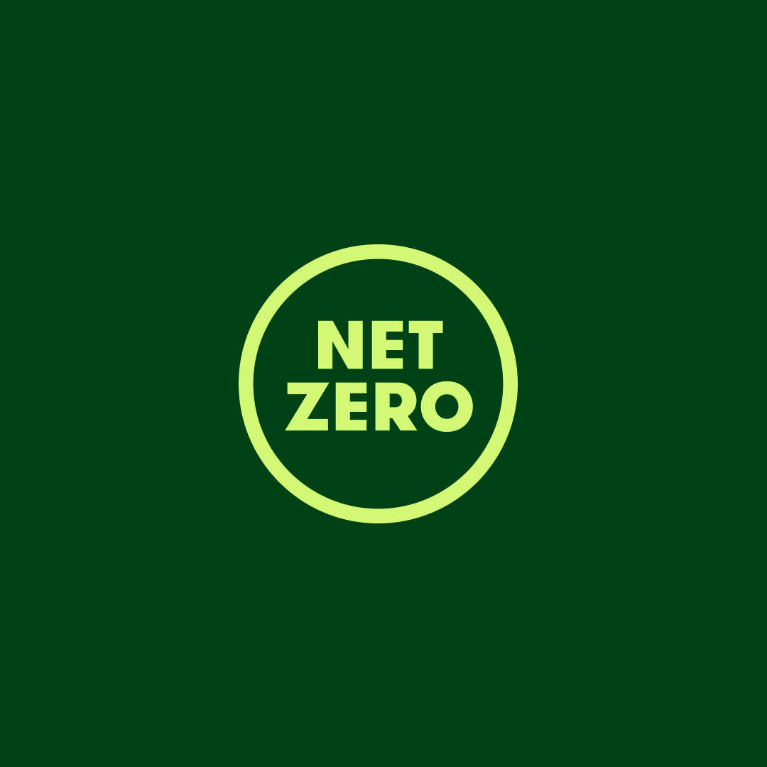 Light green circle containing the words “Net Zero” in bold capital letters on a dark green background.