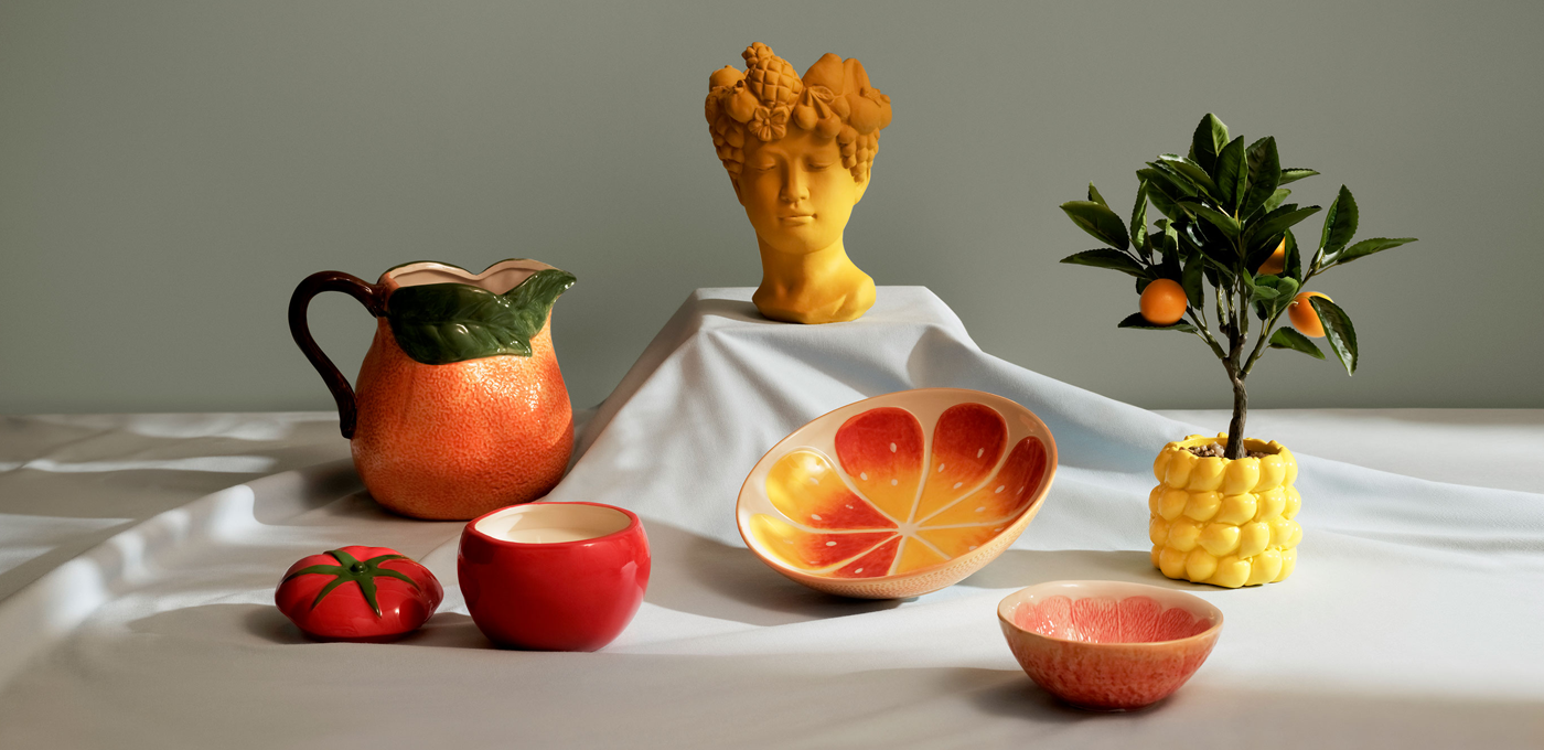 Fruit-themed ceramic dishes and decor on a table.